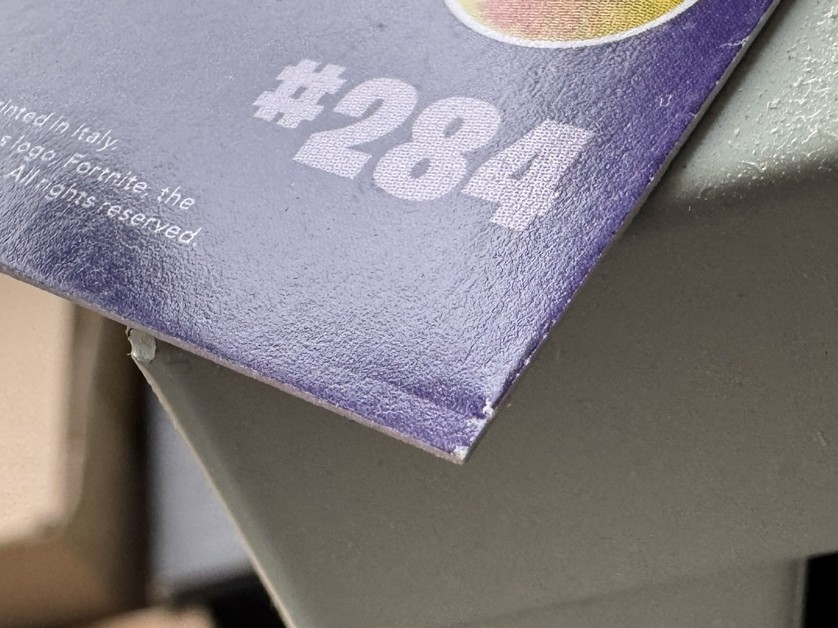 Close-up of the pinched and compressed corner defect on an Italy-print Panini Fortnite Series 1 card